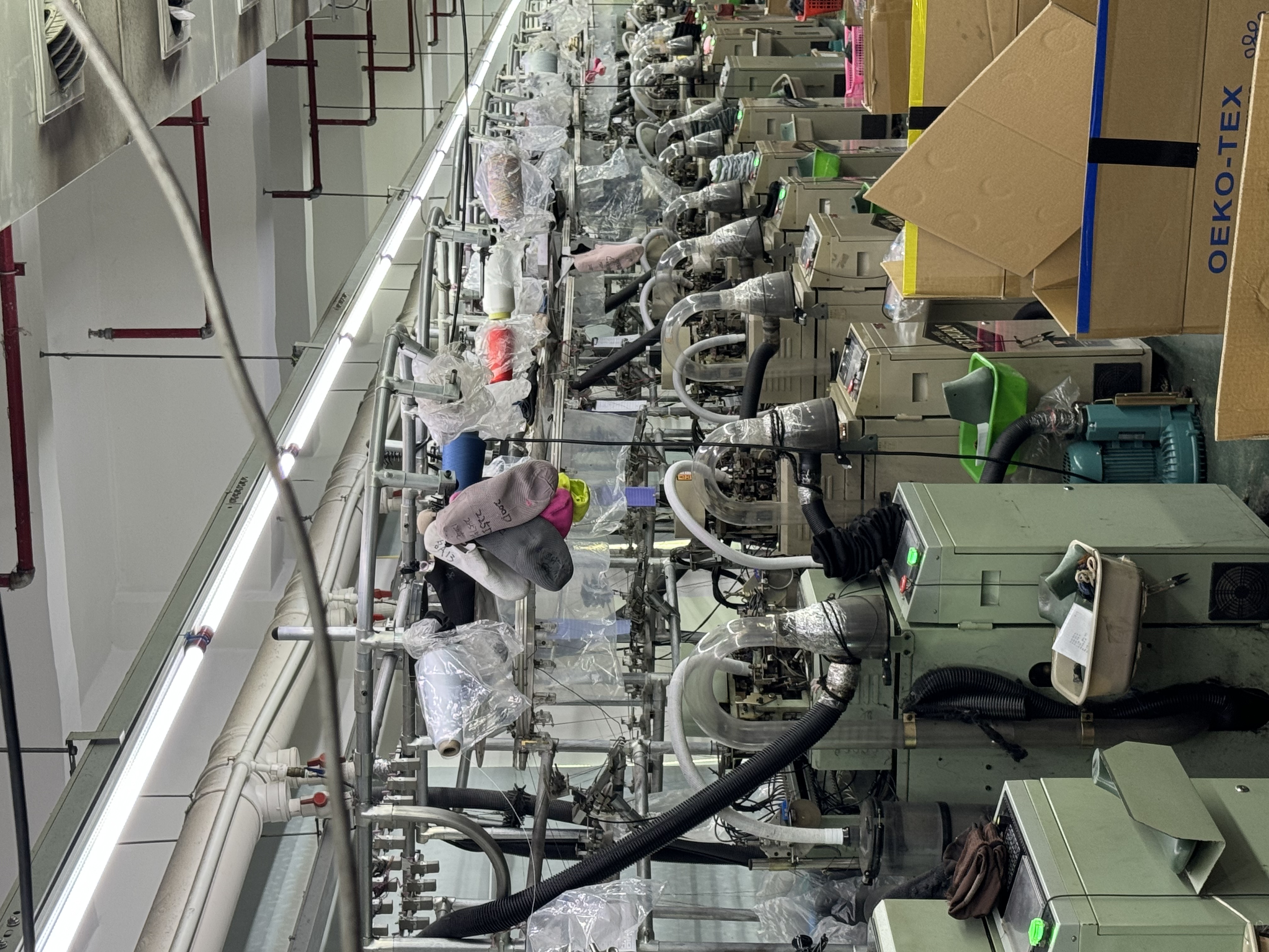 Computerised flyknit machine lines inside the Quanzhou sock shoe factory